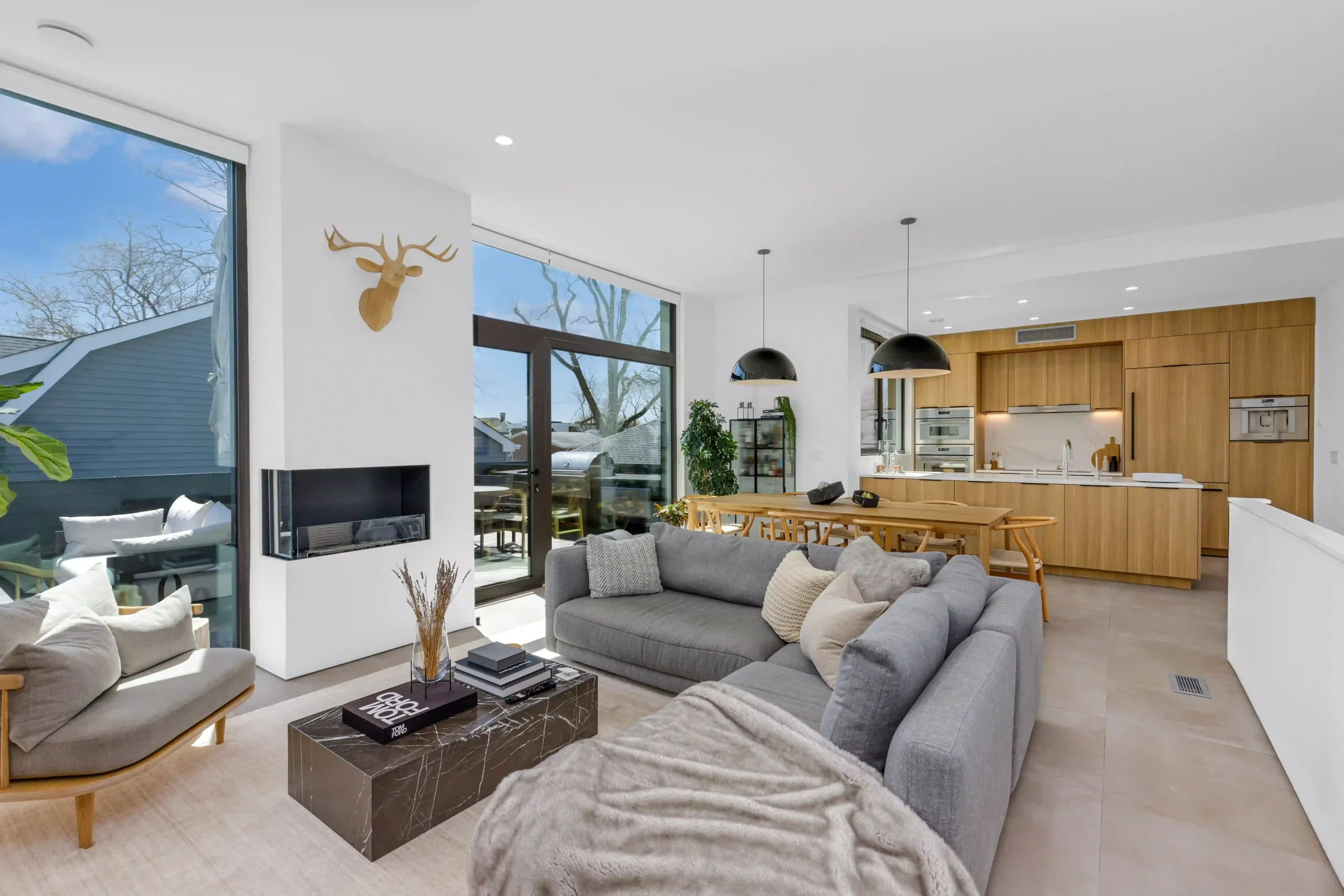 Contemporary living room with expansive glass wall, exemplifying the artistry of real estate photography.