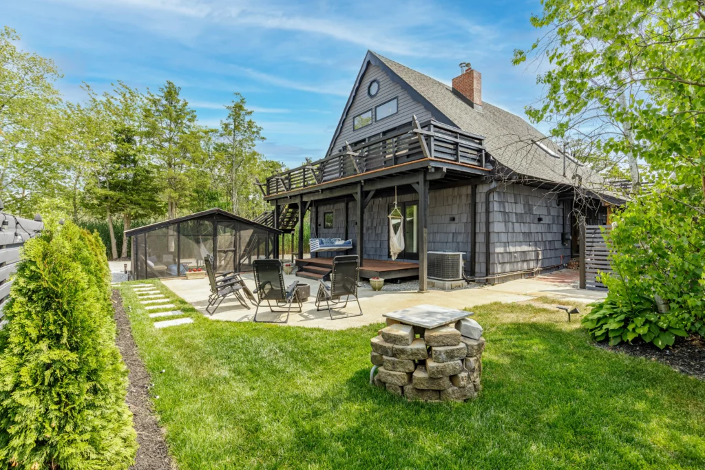 A picturesque house with a deck and lush yard, showcased through professional real estate photography.